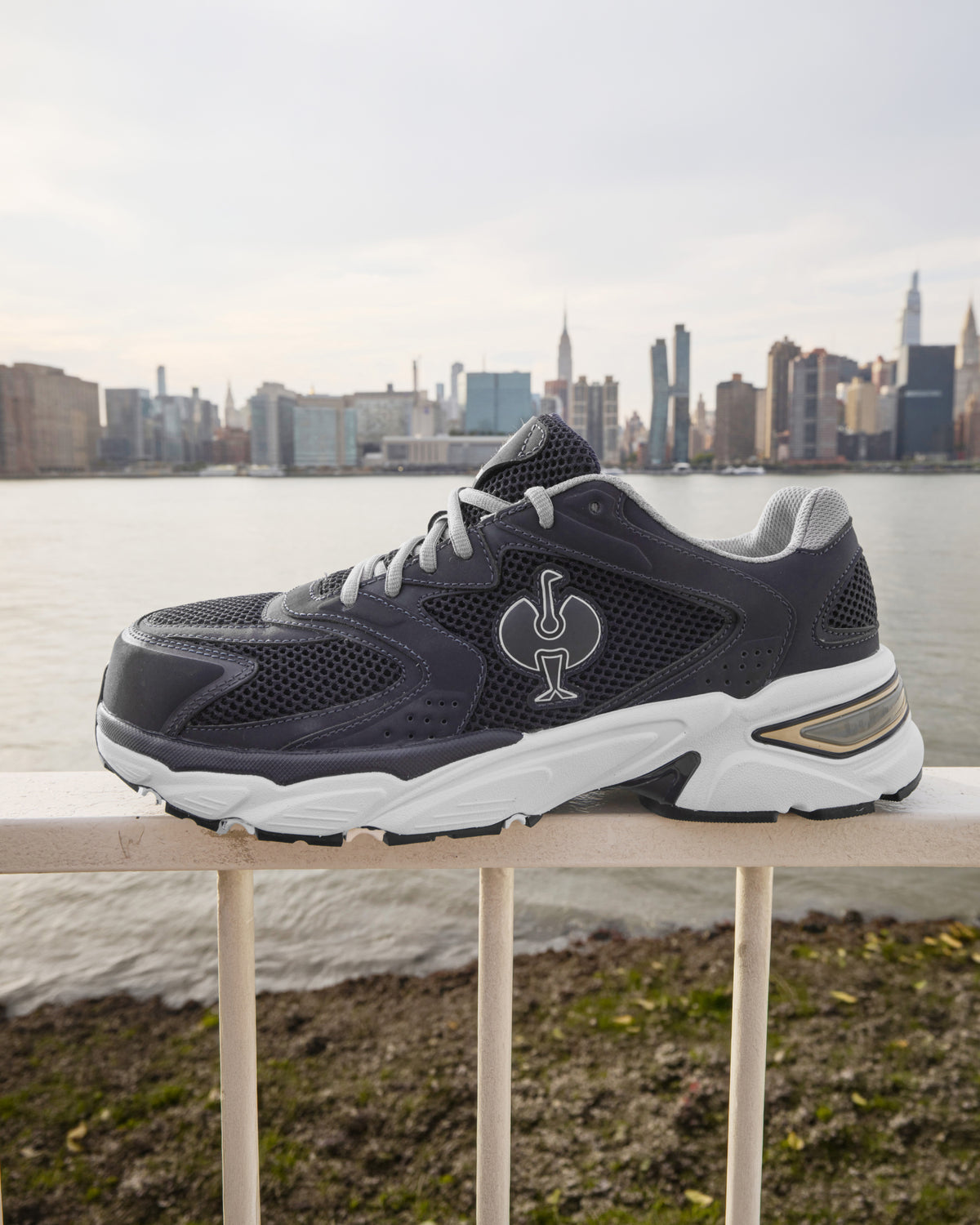 STRAUSS St. Louis Composite Toe Work Shoe in Nero blue shown on rough jobsite ground