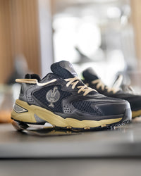 STRAUSS St. Louis Composite Toe Work Shoe in Black and Sand shown on rough jobsite ground