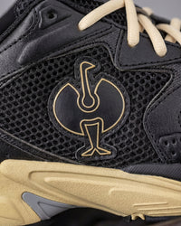 Close-up of the Black and Sand St. Louis Composite Toe Work Shoe STRAUSS logo