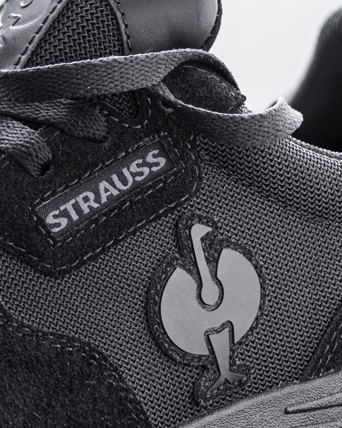 Close-up of the Canberra Steel Toe Work Shoe STRAUSS logo