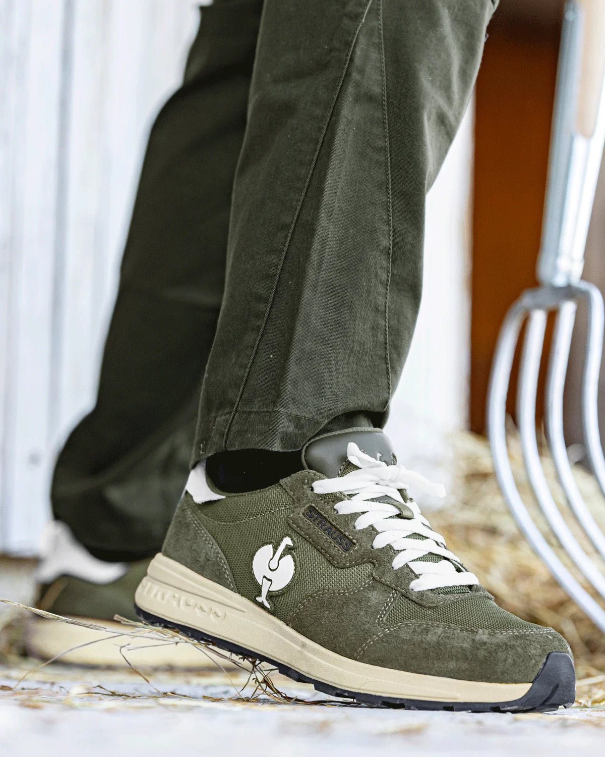 STRAUSS Canberra Steel Toe Work Shoe in Disguise green shown on rough jobsite ground