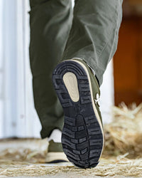 STRAUSS Canberra Steel Toe Work Shoe in Disguise green worn in an outdoor work setting