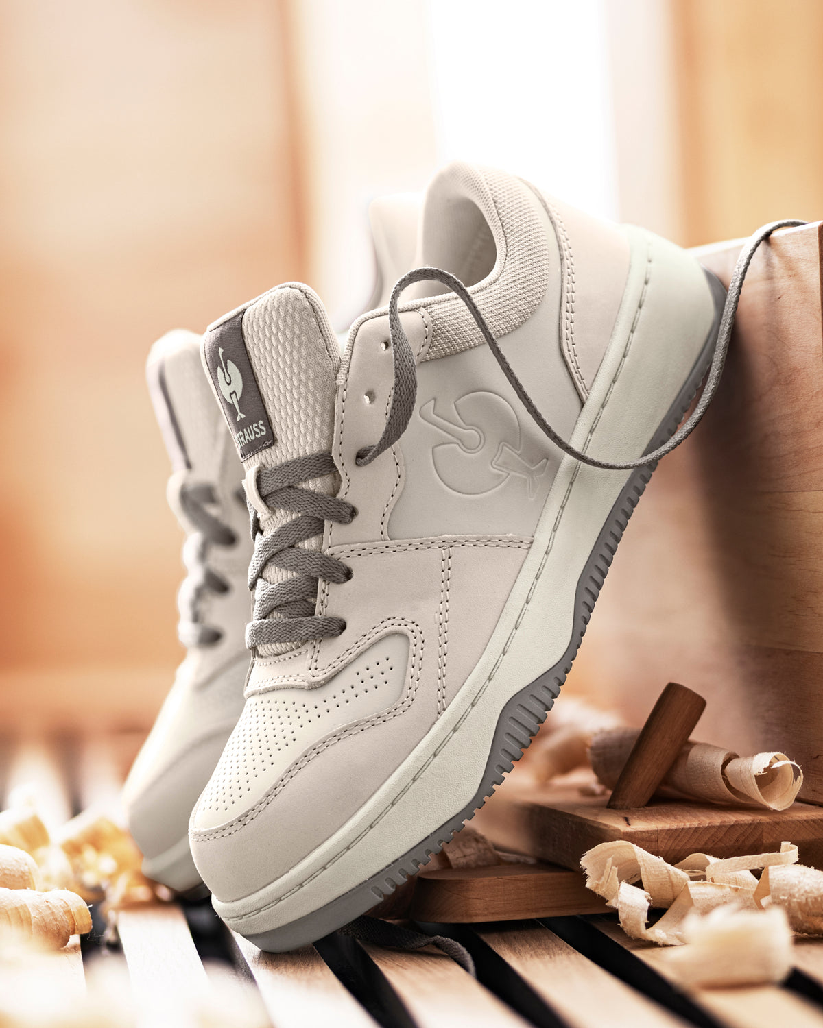 STRAUSS Eindhoven Steel Toe Work Shoe in Cream stone and Gray shown on rough jobsite ground