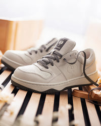 STRAUSS Eindhoven Steel Toe Work Shoe in Cream stone and Gray worn in an outdoor work setting