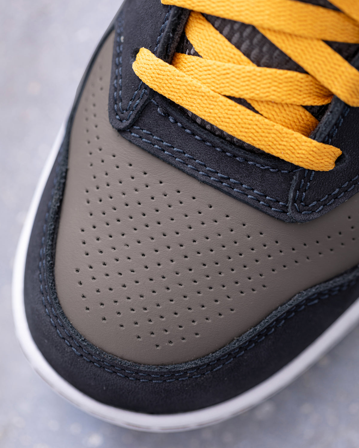 STRAUSS Eindhoven Steel Toe Work Shoe in Nero blue and Stone gray shown in use on the job