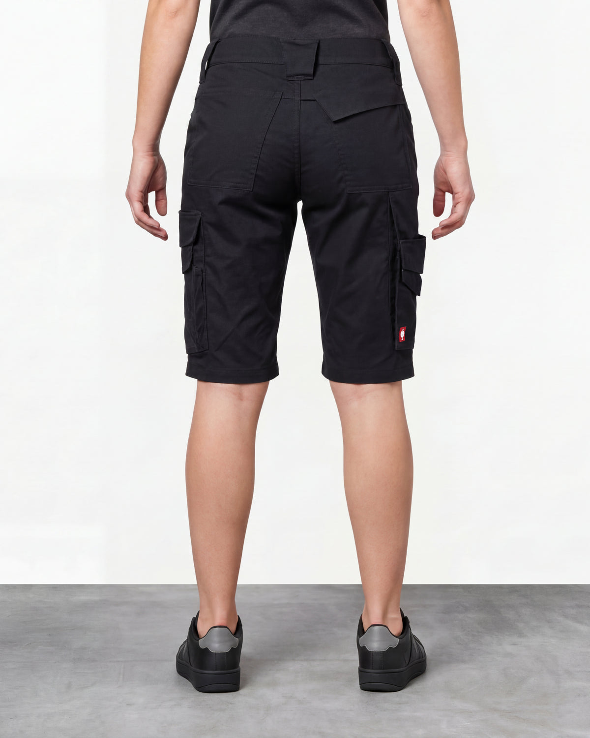 Alternate model view of Engelbert Strauss women's e.s. trail pure cargo work shorts in black and carbon gray, showing the side and back fit with visible utility pocket placement and workwear construction.