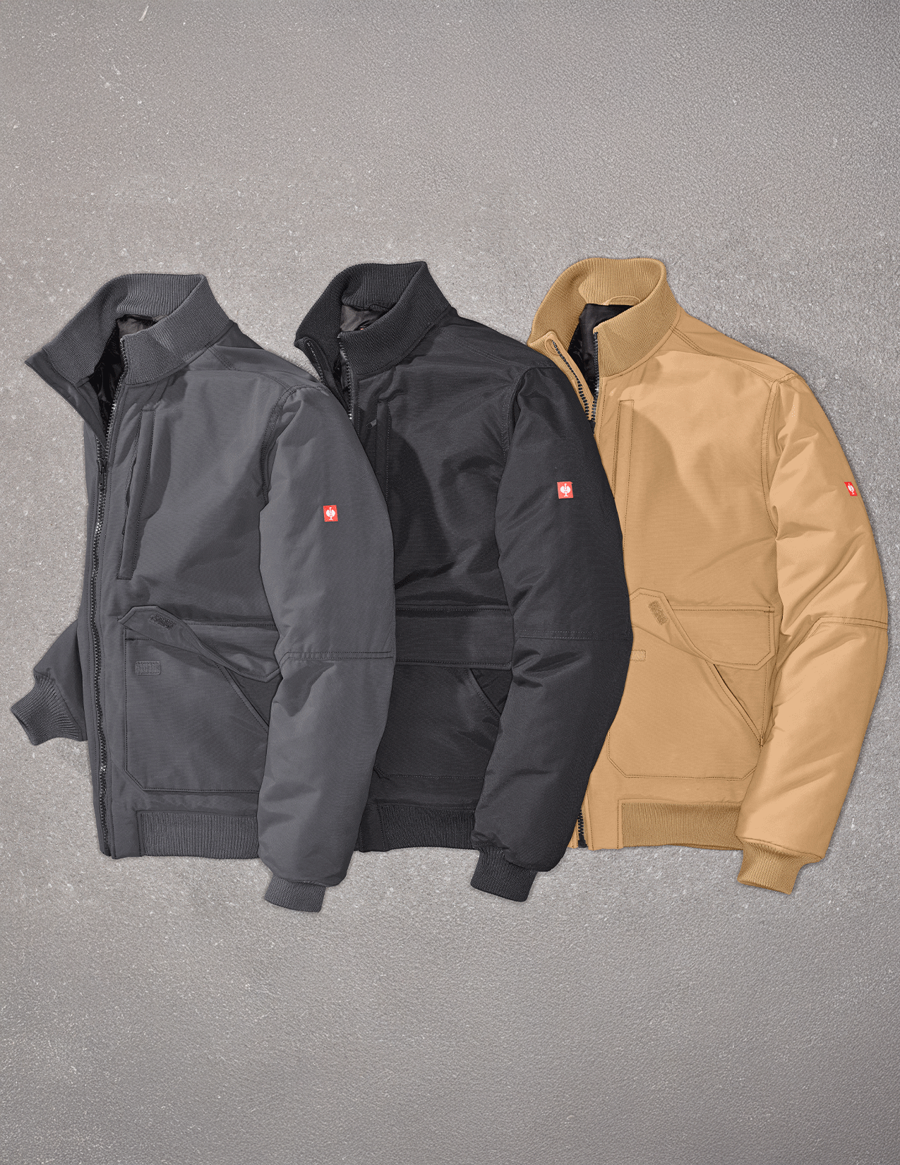 Three jackets in gray, black, and almondbrown on a gray background