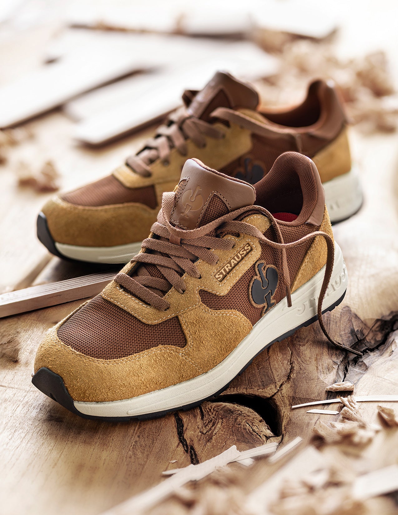 Brown and beige sneakers on a wooden surface