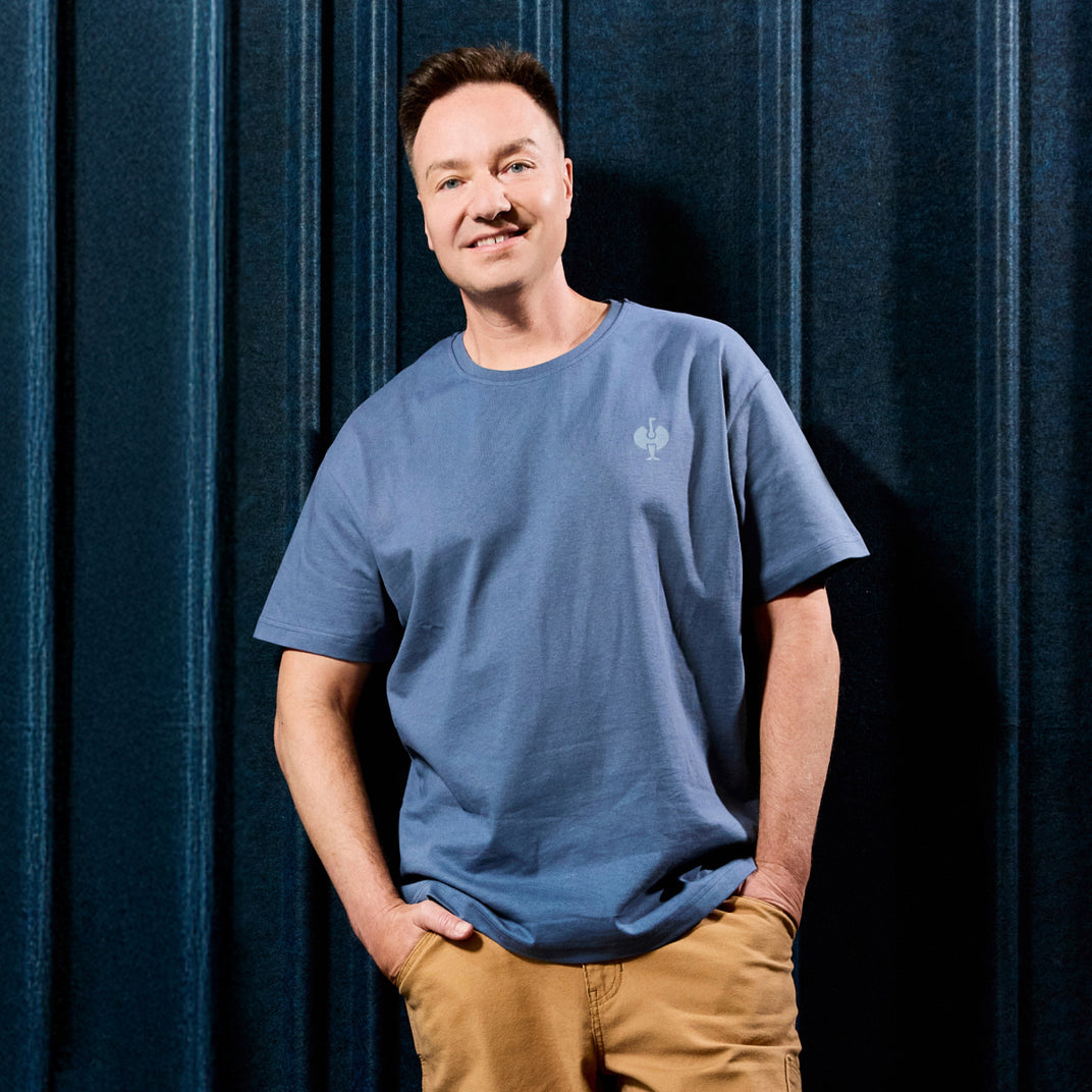Henning Strauss stands confidently in front of a felt background