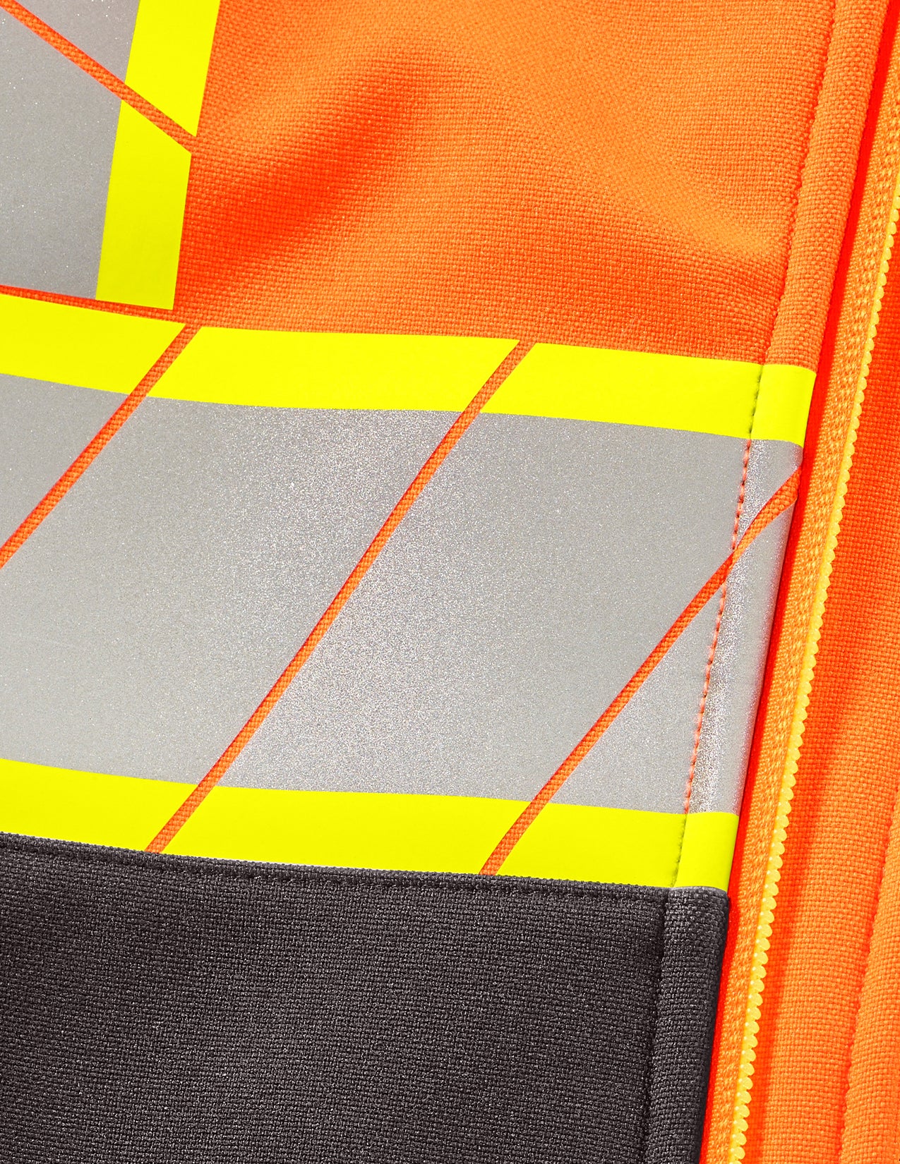 Close-up of a reflective safety vest with orange, gray, and yellow colors.