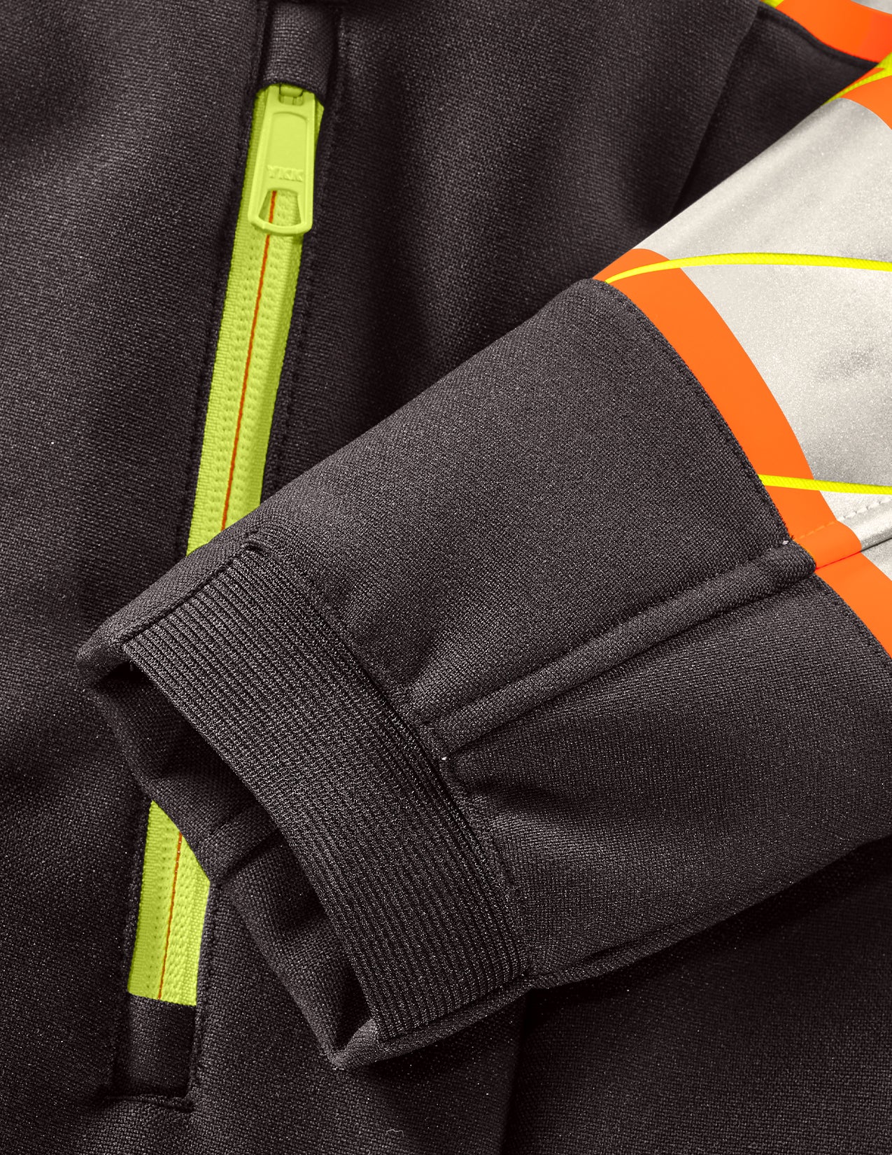 Close-up of a black jacket with reflective orange and yellow accents