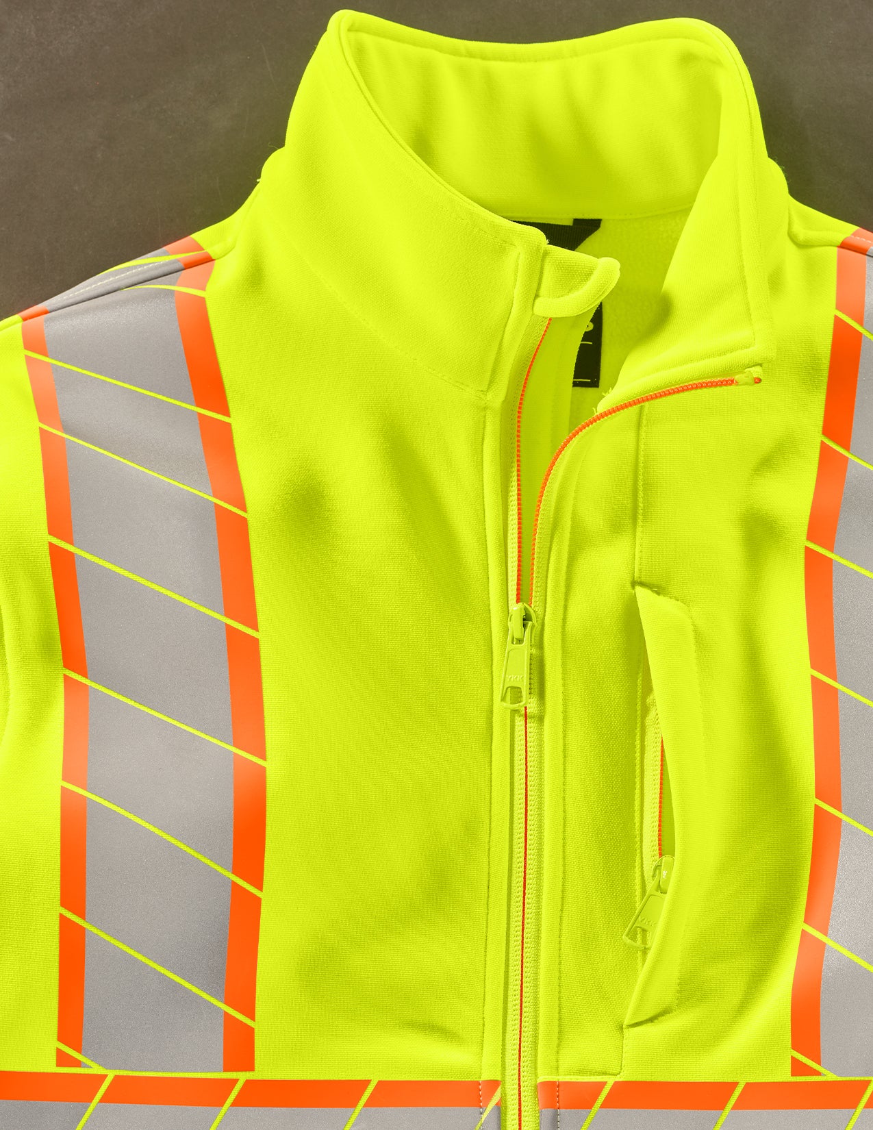 Fluorescent yellow safety vest with reflective stripes on a gray background