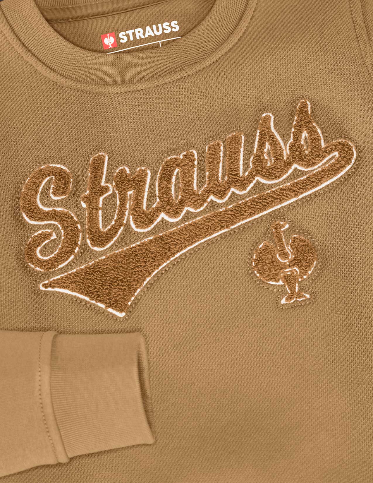 Brown sweatshirt with 'Strauss' branding and logo on a close-up view.