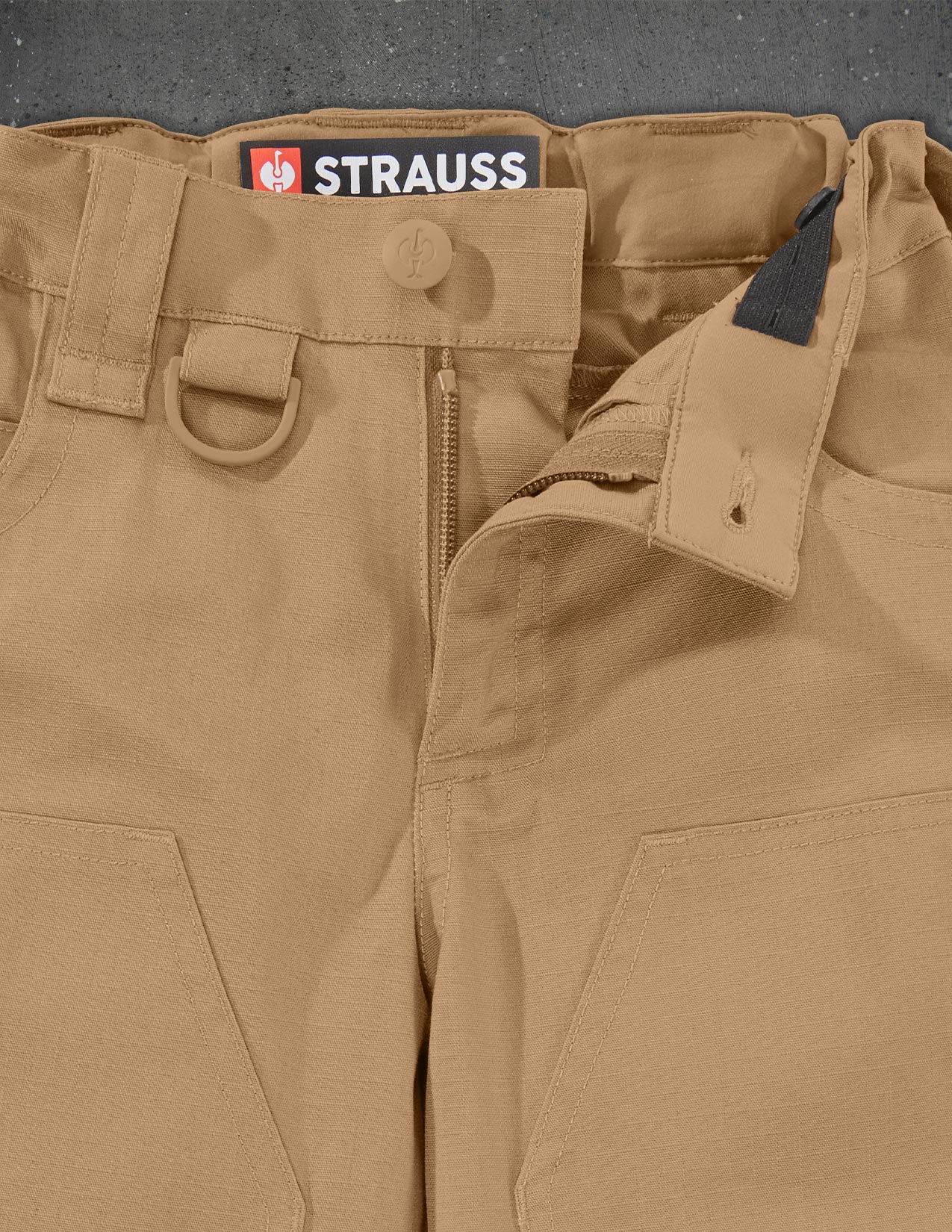 Close-up of brown pants with a Strauss label on a gray background