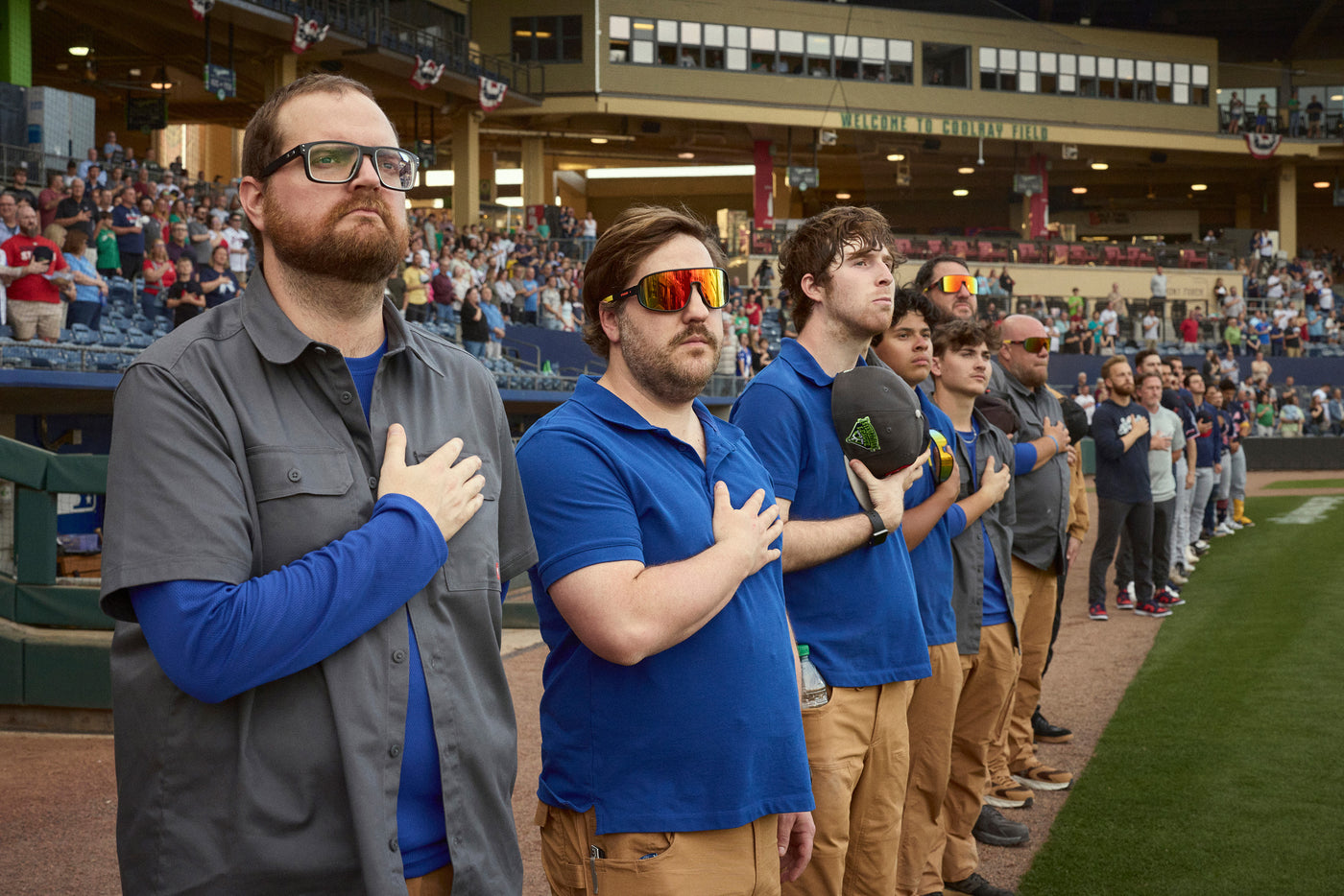 People stand for the national anthem