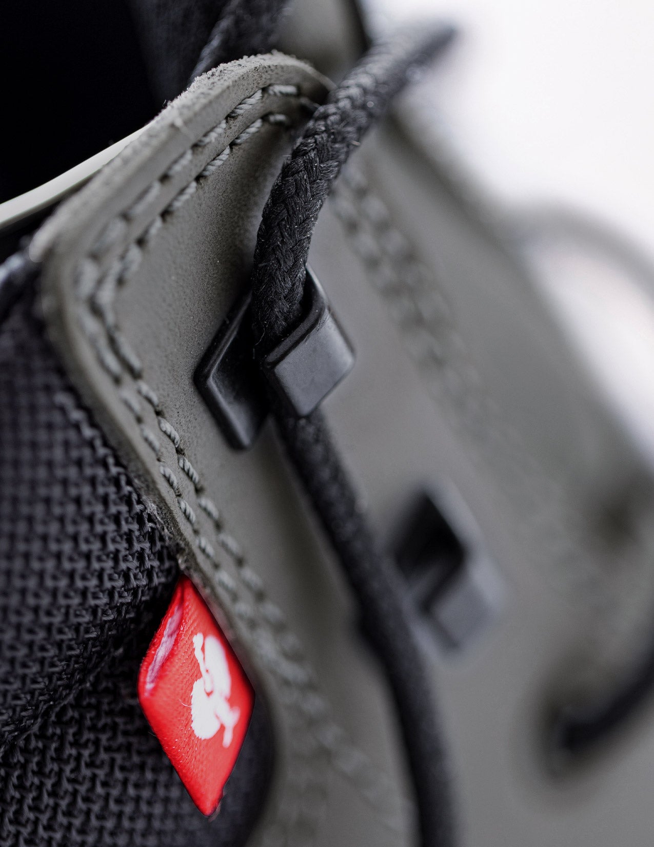 Close-up of a textured surface with a red label featuring a logo.