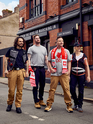 Henning Strauss with people wearing Strauss workwear and Liverpool fanwear