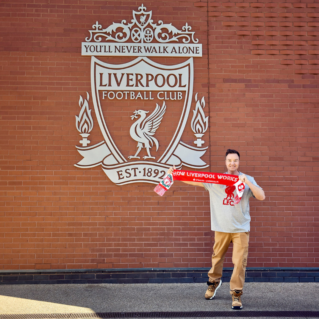 Henning Strauss standing before the Liverpool Logo