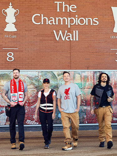 Henning Strauss with people wearing Strauss workwear and Liverpool fanwear