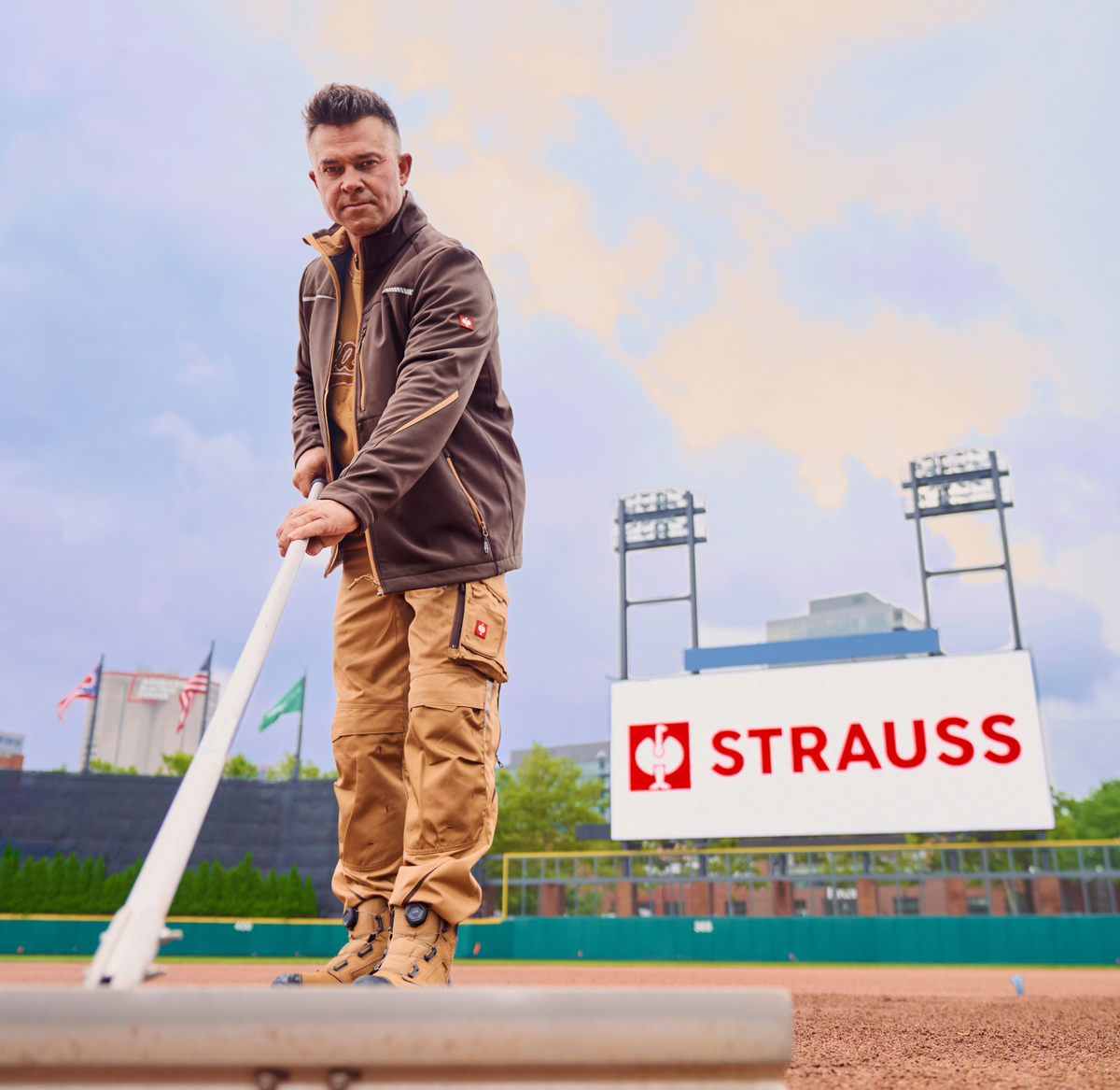 Nick Swisher smoothing the ground on a baseball field