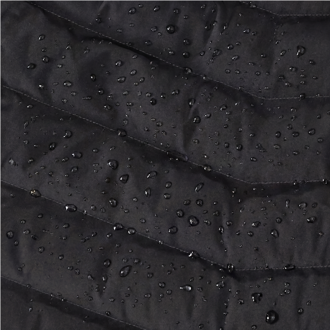 Close-up of black fabric with water droplets on a textured surface