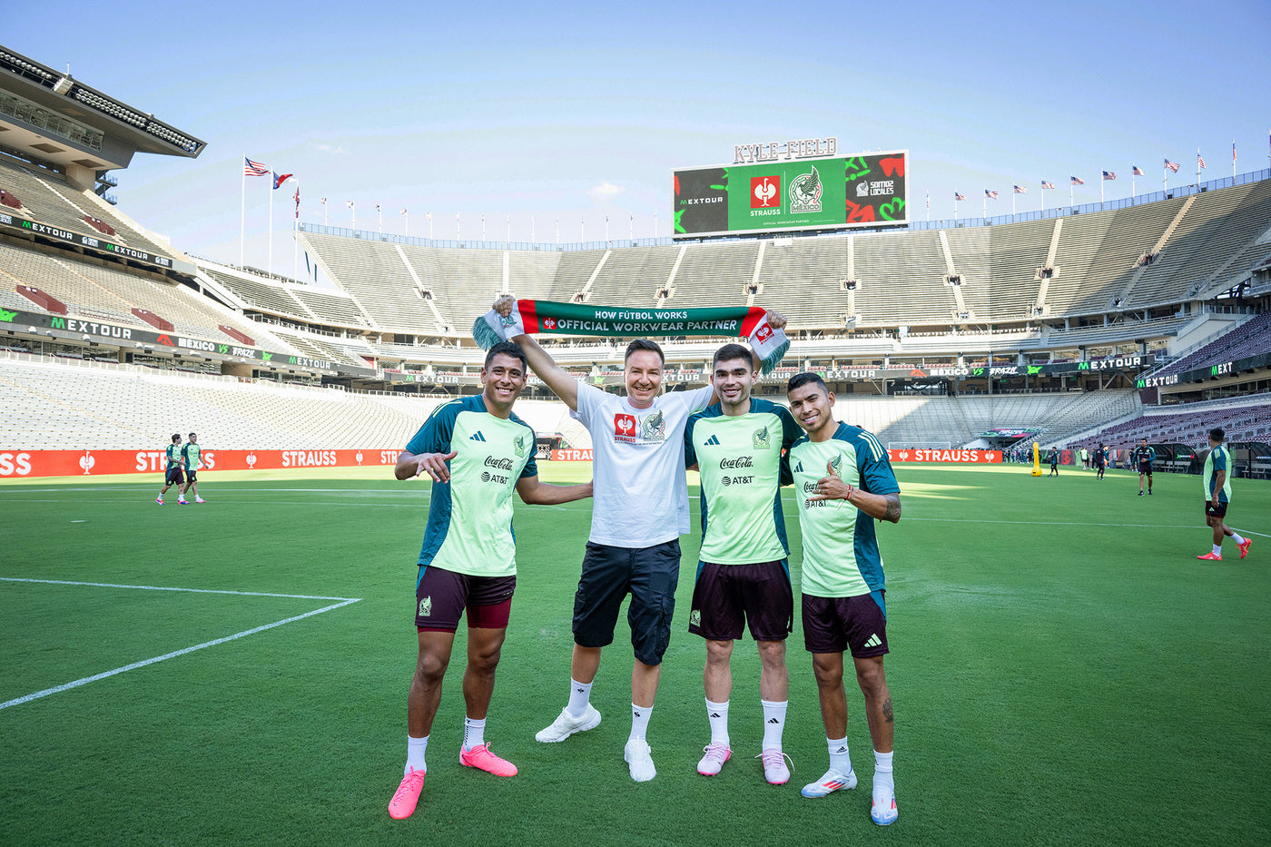 Henning Strauss with mexican players in a stadium