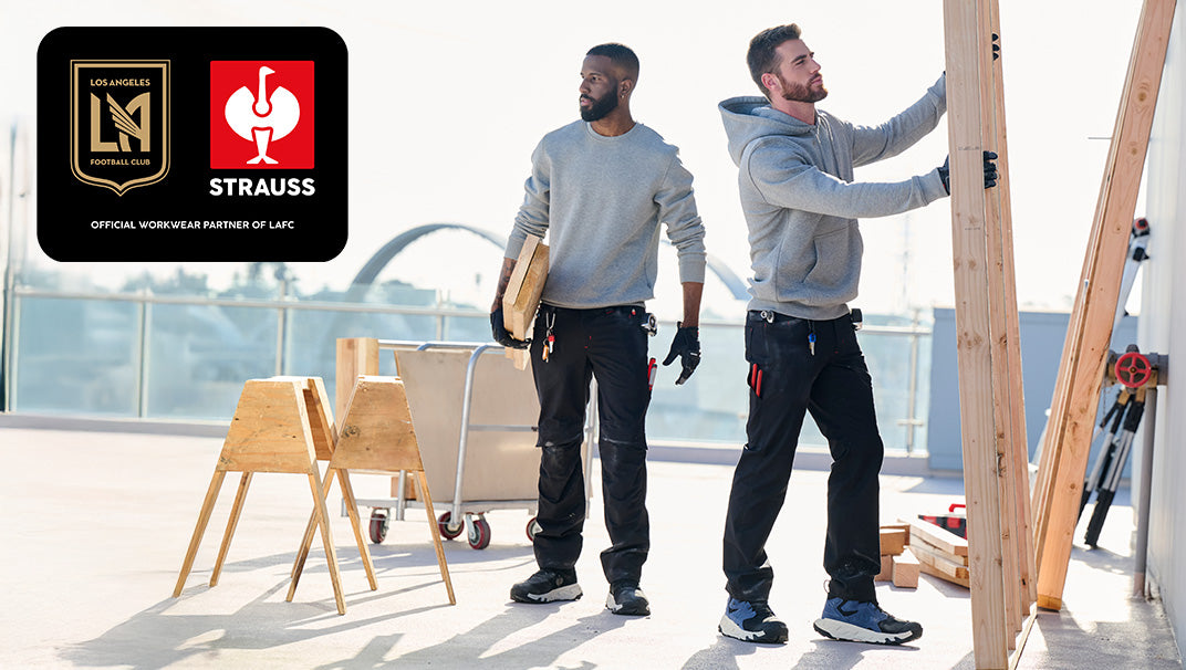 Two tradespeople work on a roof in STRAUSS workwear