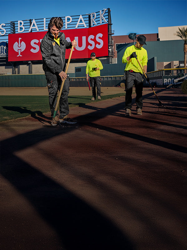 workers with strauss workwear in a baseball ballpark