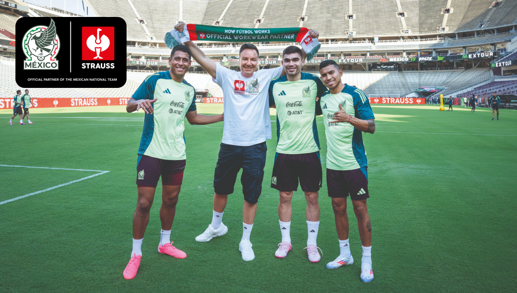 CEO Henning Strauss standing next to soccer players in the middle of a soccer stadium 