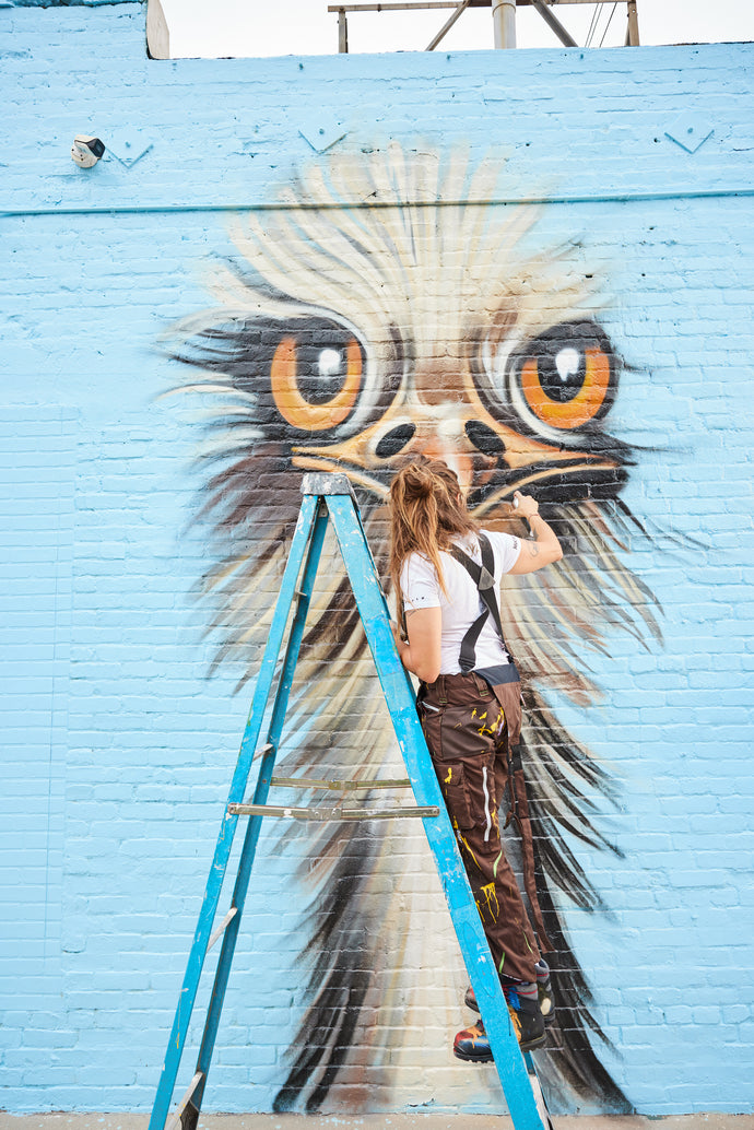 Jules Muck painting the ostrich Mural
