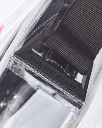 Close-up of the transparent pouch, zipper, and strap on the clear STRAUSS e.s.e:pic crossbody bag.