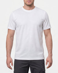 A model wears the STRAUSS Performance T-Shirt in white with tan work pants and work boots in a studio product scene