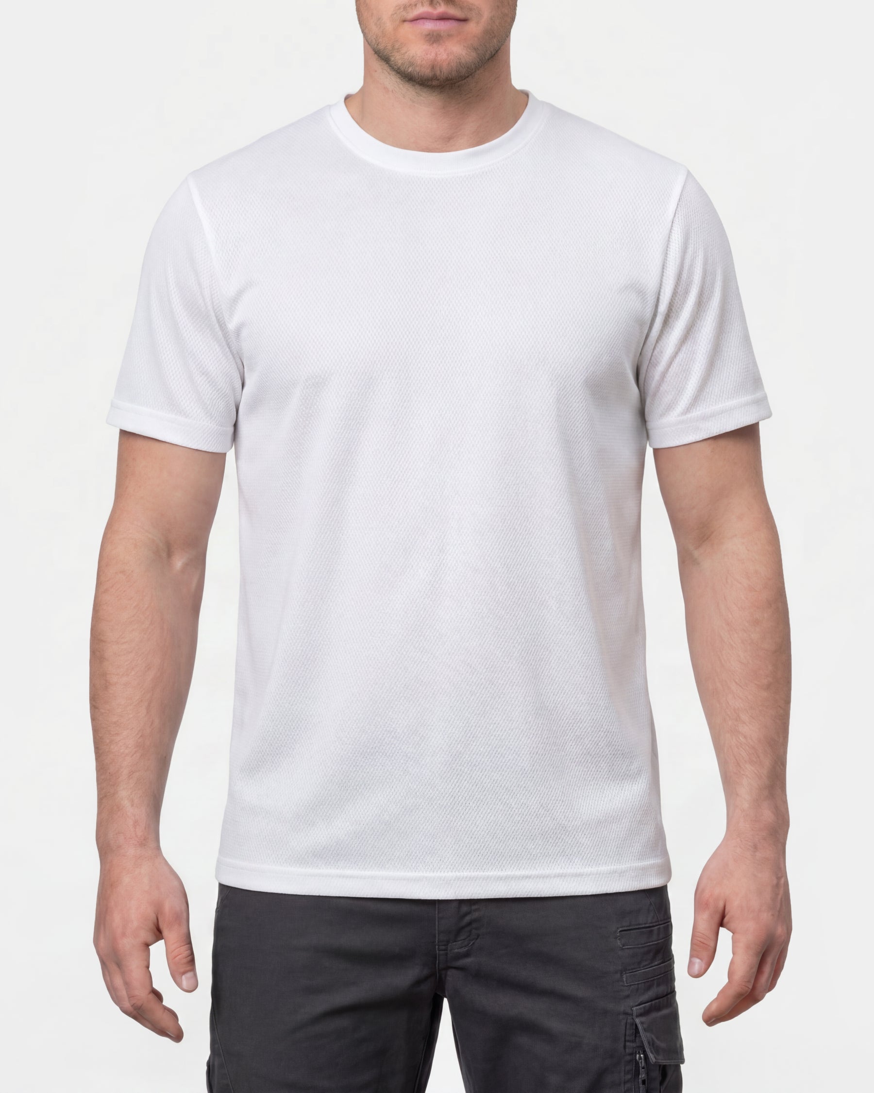 A model wears the STRAUSS Performance T-Shirt in white with tan work pants and work boots in a studio product scene