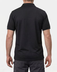 A model wears the STRAUSS Performance Polo Shirt in black