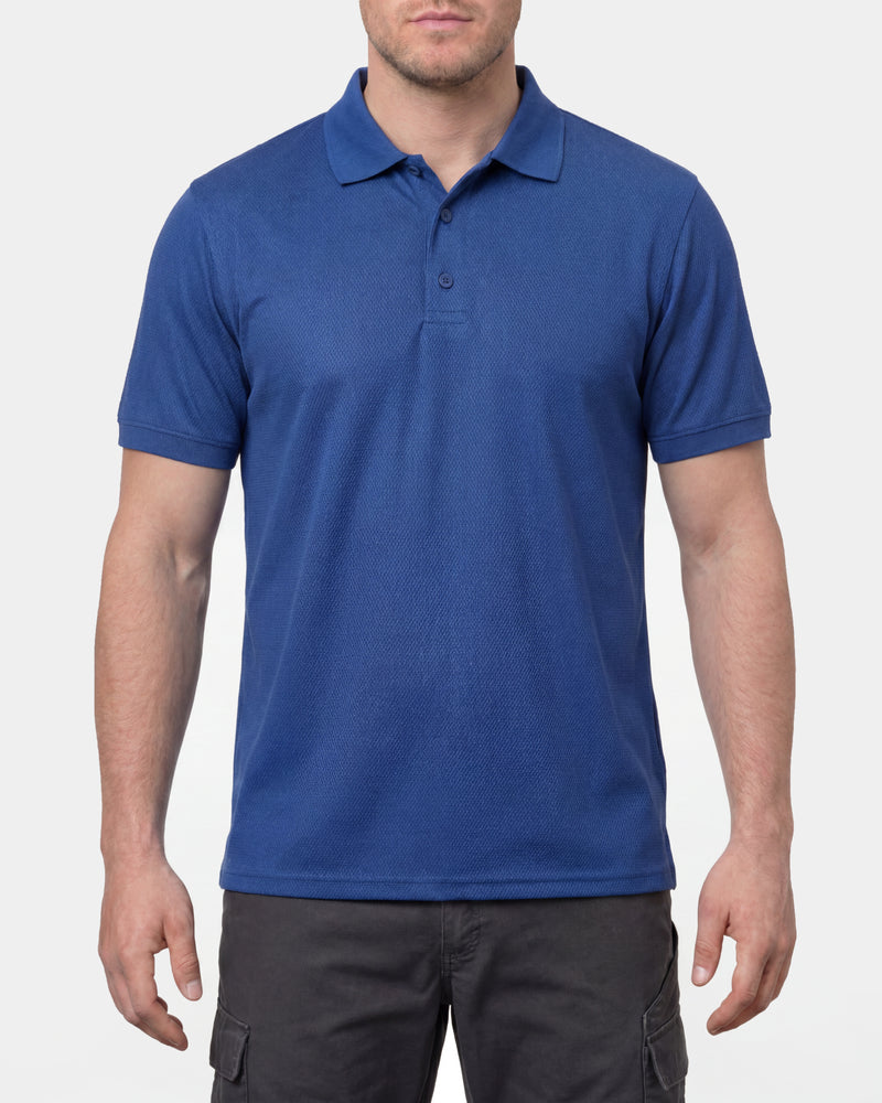 A model wears the STRAUSS Performance Polo Shirt in royal blue in a studio product scene