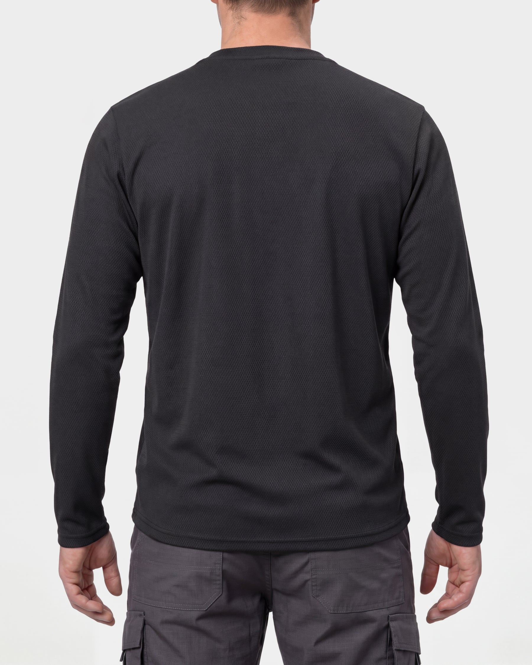 A model wears the STRAUSS Performance Long Sleeve Shirt in black