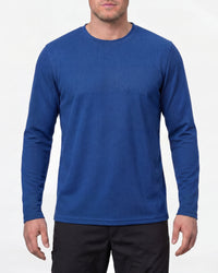 A model wears the STRAUSS Performance Long Sleeve Shirt in royal blue in a studio product scene