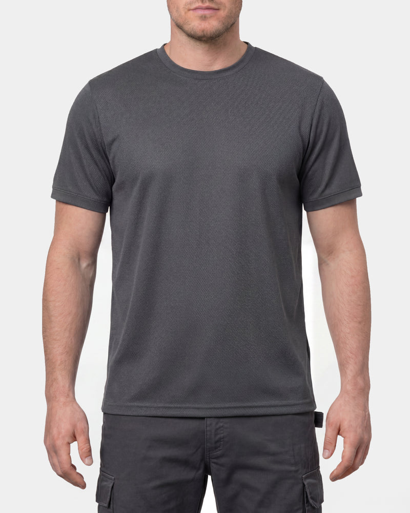 A model wears the STRAUSS Performance T-Shirt in carbon gray in a studio product scene