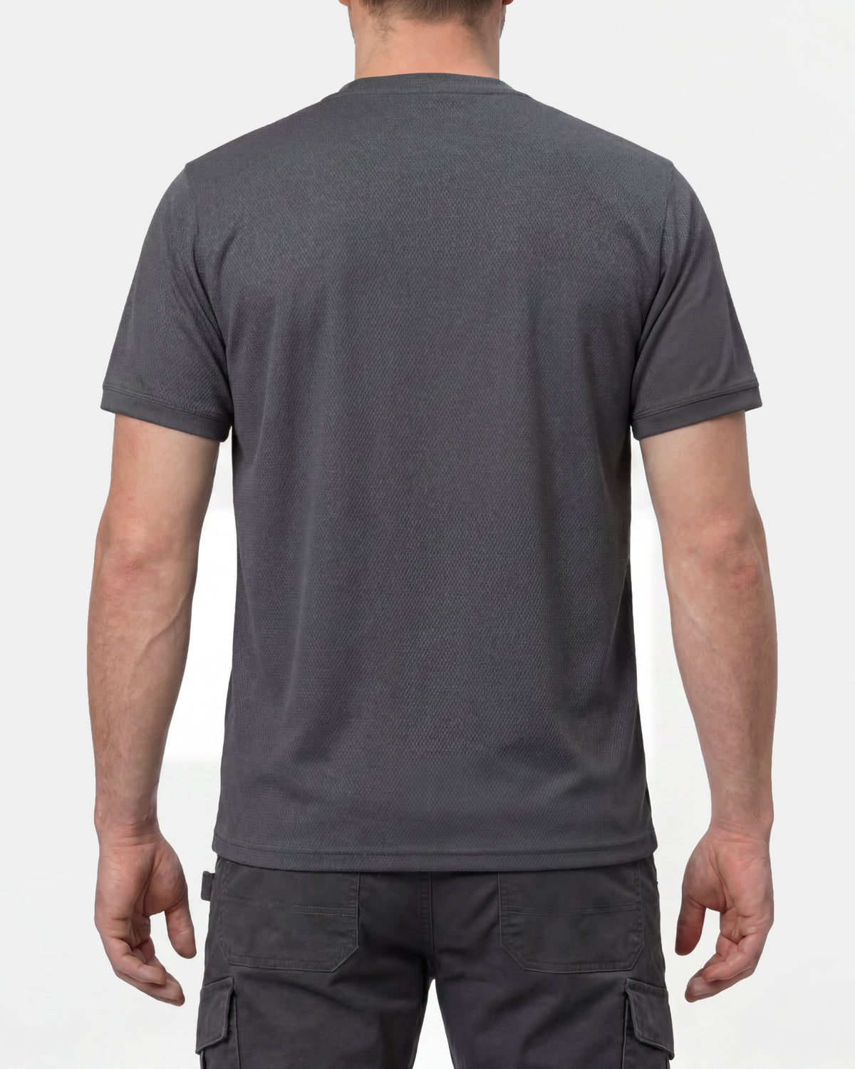 A model wears the STRAUSS Performance T-Shirt in carbon gray, showing the shirt fit