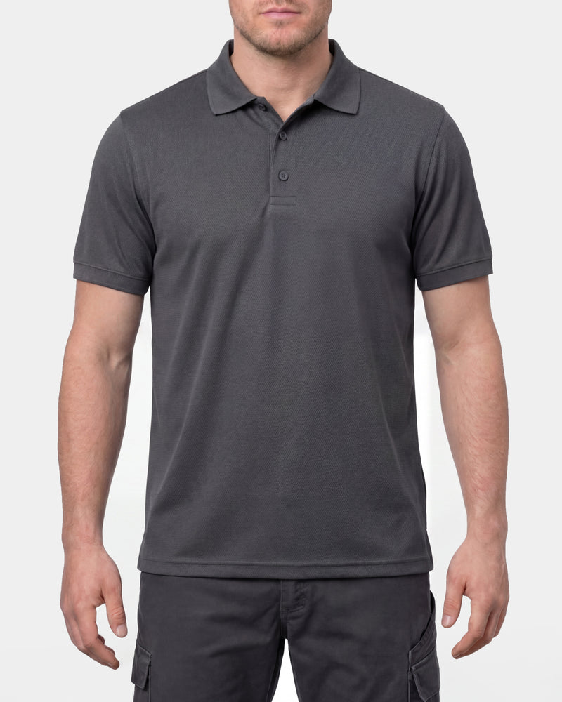 A model wears the STRAUSS Performance Polo Shirt in carbon gray in a studio product scene