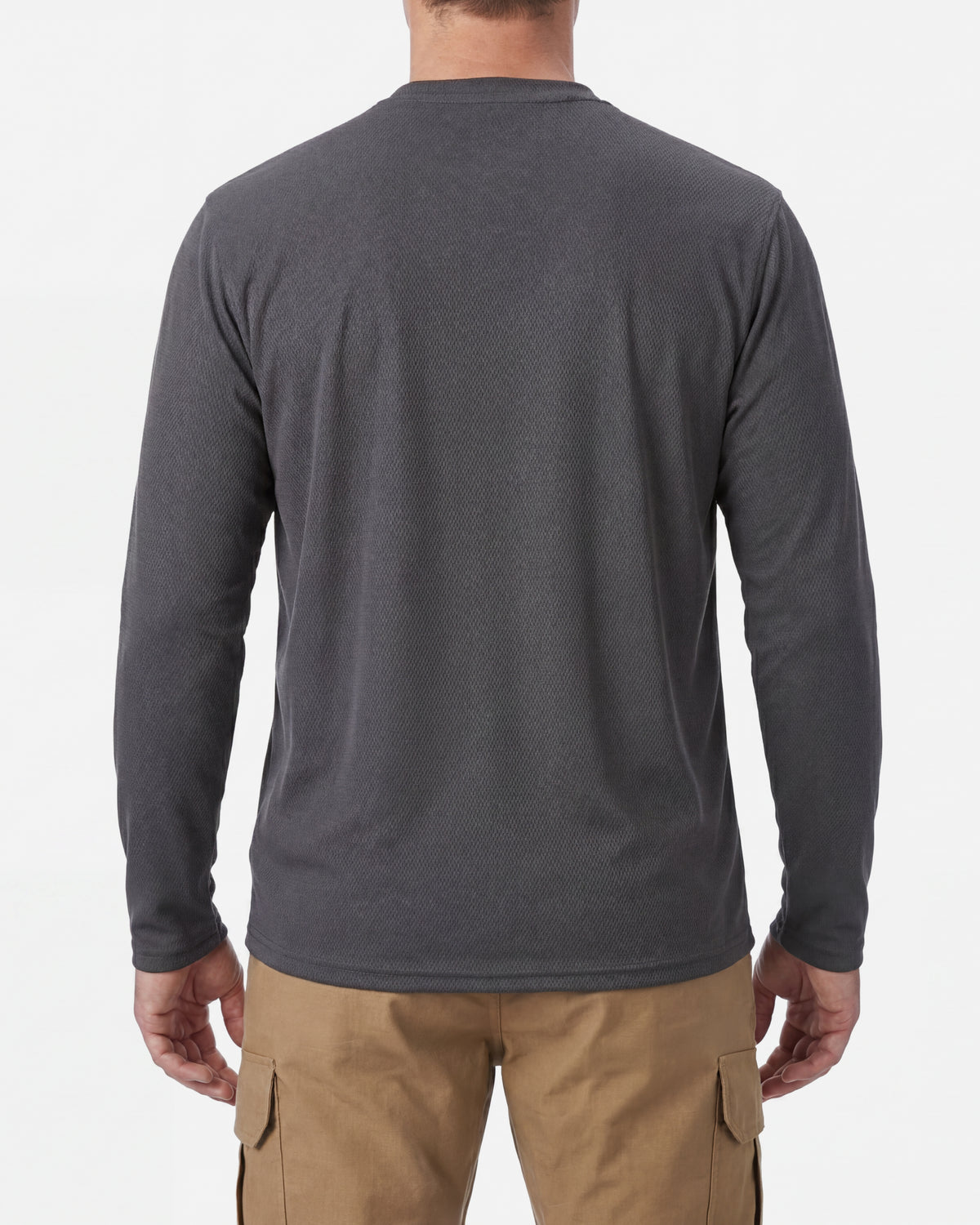 A model wears the STRAUSS Performance Long Sleeve Shirt in carbon gray with tan work pants and work boots, showing the shirt fit