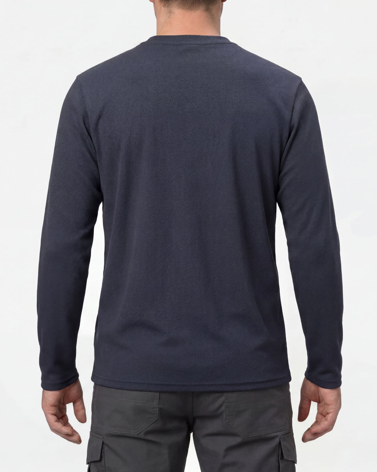 A model wears the STRAUSS Performance Long Sleeve Shirt in nero blue with tan work pants and work boots, showing the shirt fit