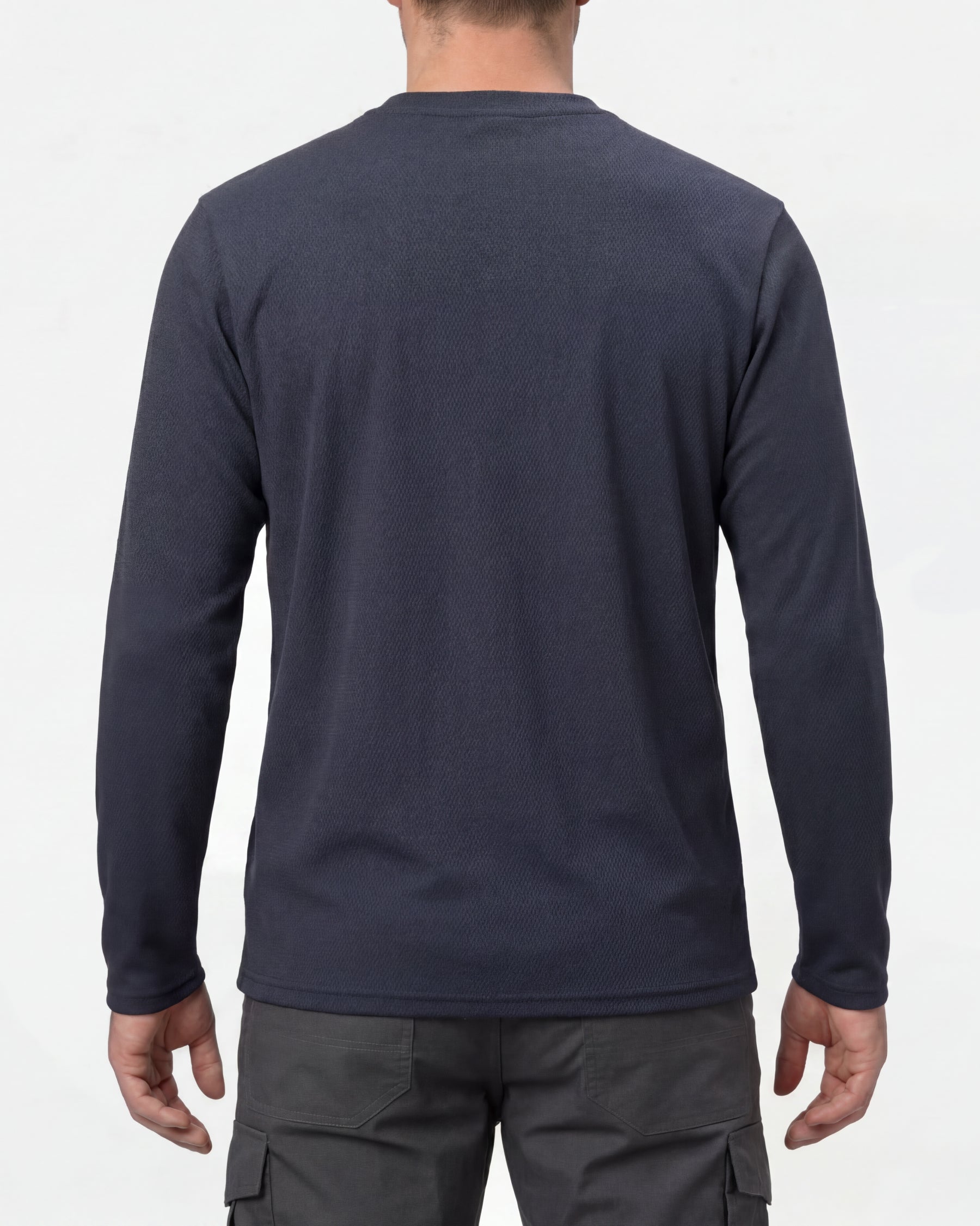 A model wears the STRAUSS Performance Long Sleeve Shirt in nero blue with tan work pants and work boots, showing the shirt fit
