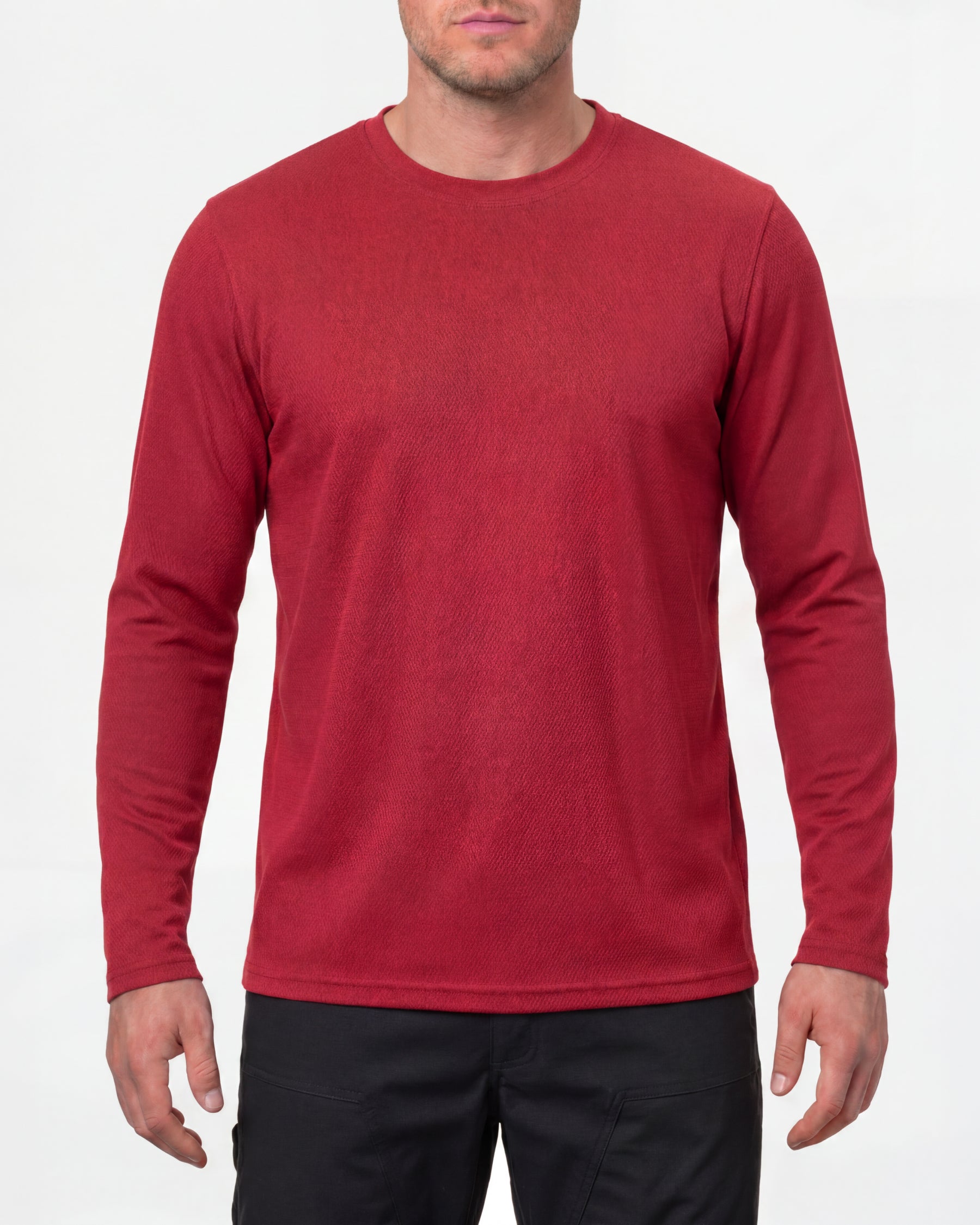 A model wears the STRAUSS Performance Long Sleeve Shirt in fire red with tan work pants and work boots in a studio product scene