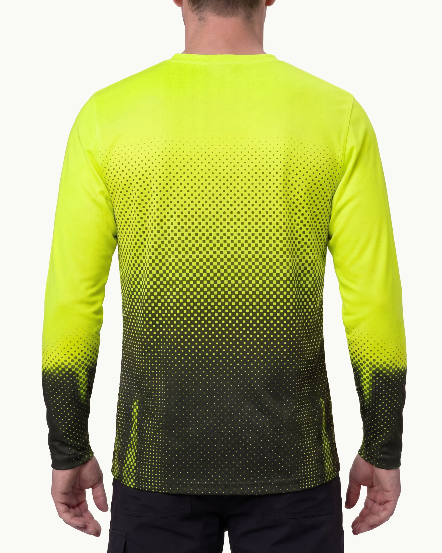 A model wears the STRAUSS Enhanced Visibility Performance Long Sleeve Shirt e.s.t:aktik in neon yellow and black with black work pants in a high-visibility workwear outfit, showing the shirt fit