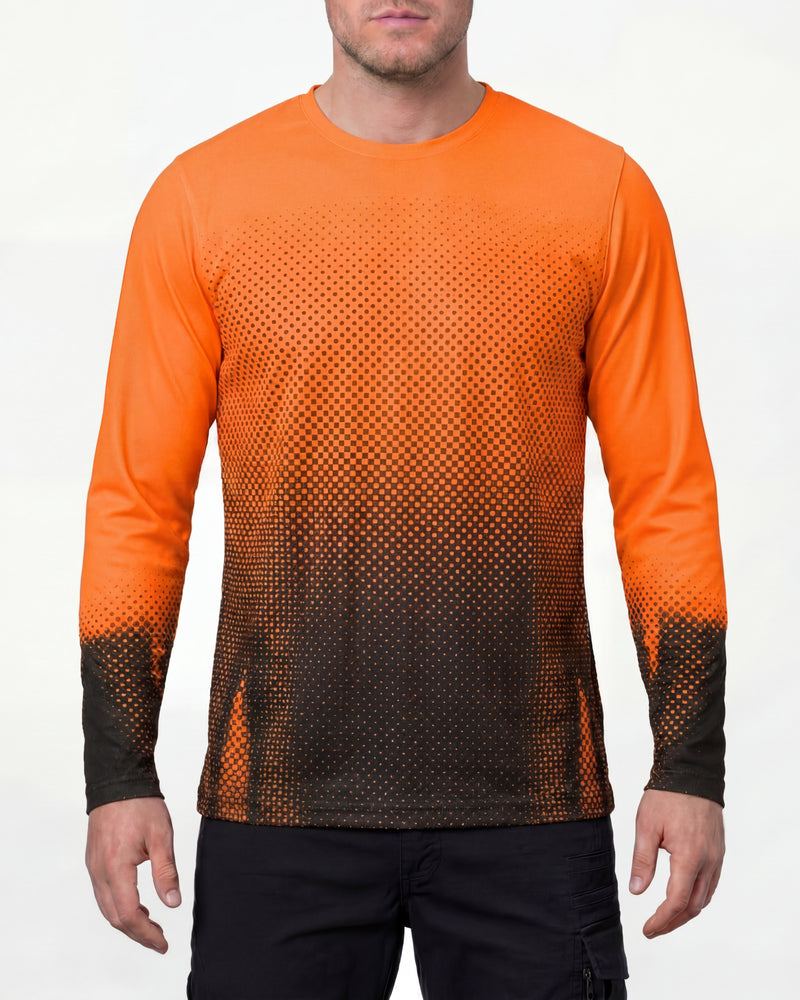 A model wears the STRAUSS Enhanced Visibility Performance Long Sleeve Shirt e.s.t:aktik in neon orange and black with black work pants in a high-visibility workwear outfit in a studio product scene
