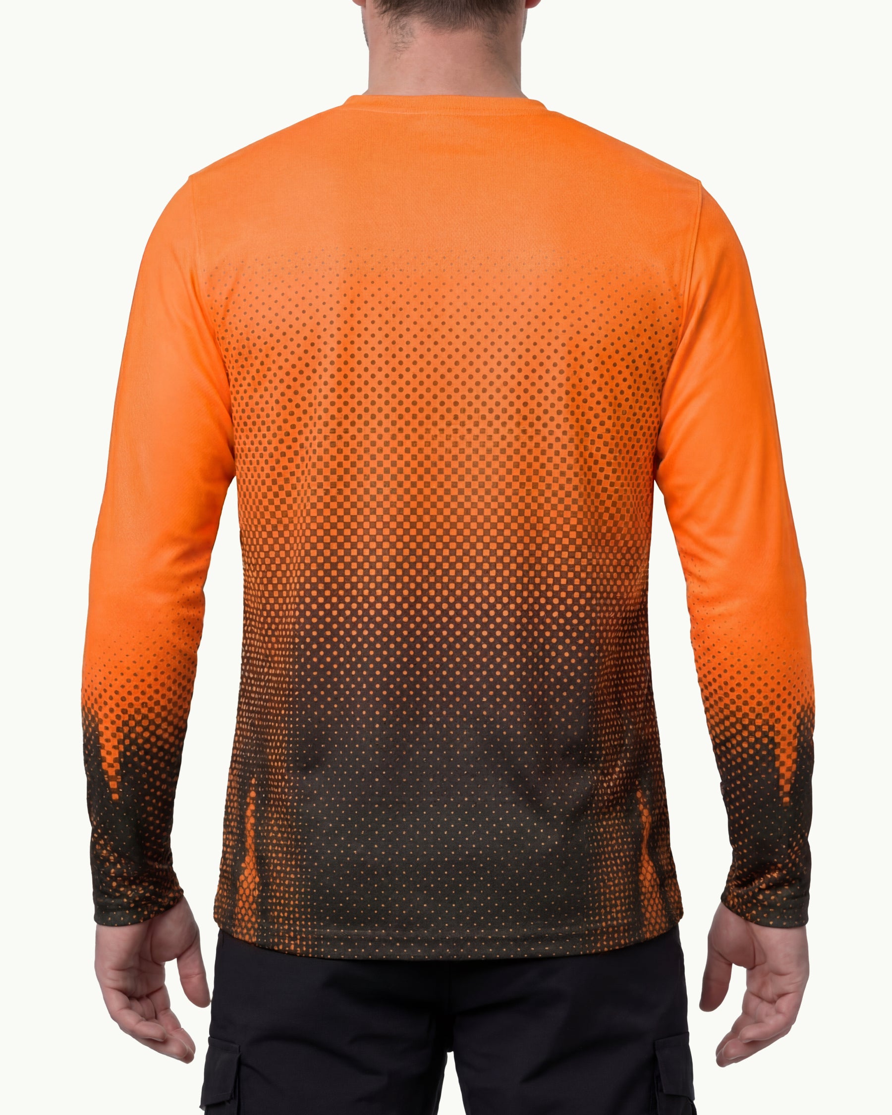 A model wears the STRAUSS Enhanced Visibility Performance Long Sleeve Shirt e.s.t:aktik in neon orange and black with black work pants in a high-visibility workwear outfit, showing the shirt fit