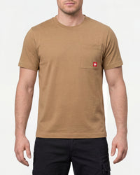 A model wears the STRAUSS Pocket T-Shirt e.s.iconic in almond brown with work pants and work boots in a studio product scene