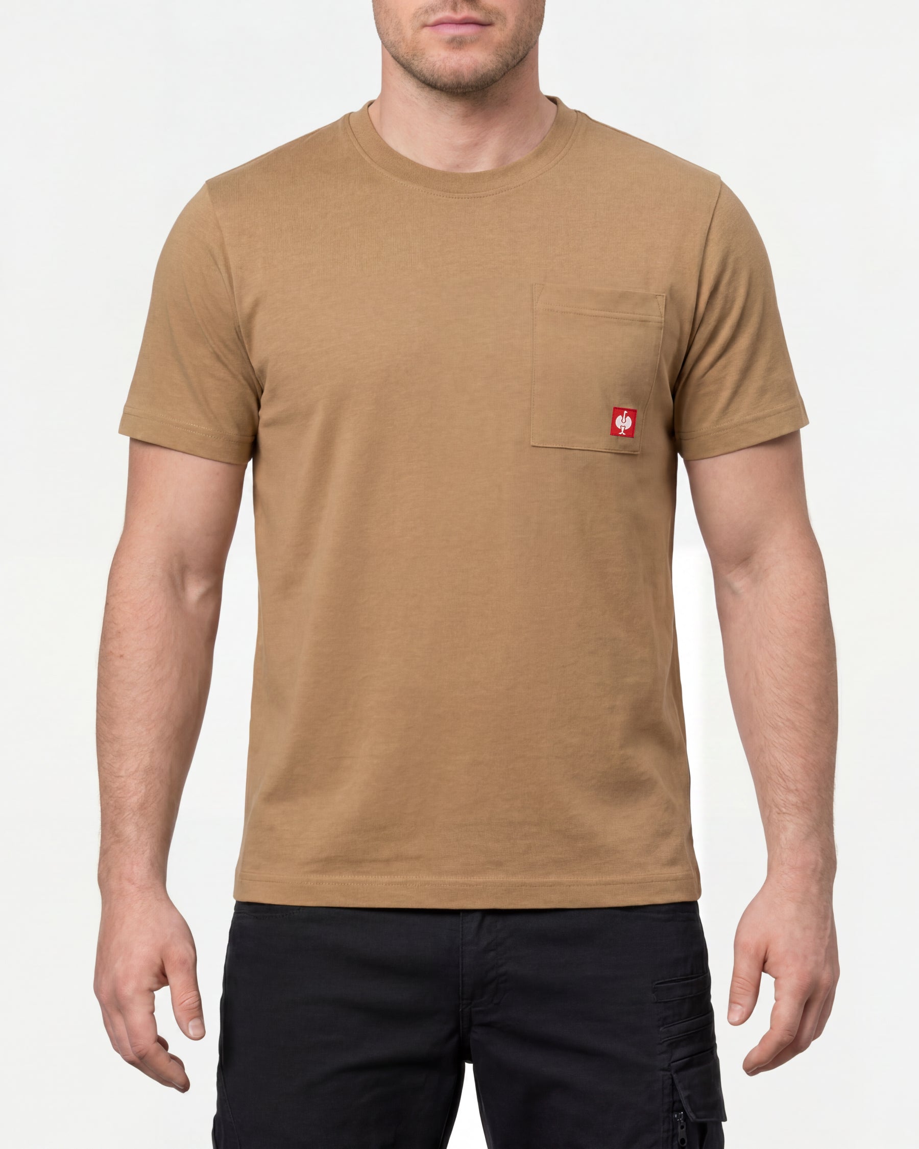 A model wears the STRAUSS Pocket T-Shirt e.s.iconic in almond brown with work pants and work boots in a studio product scene
