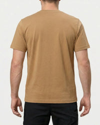 A model wears the STRAUSS Pocket T-Shirt e.s.iconic in almond brown with work pants and work boots, showing the shirt fit